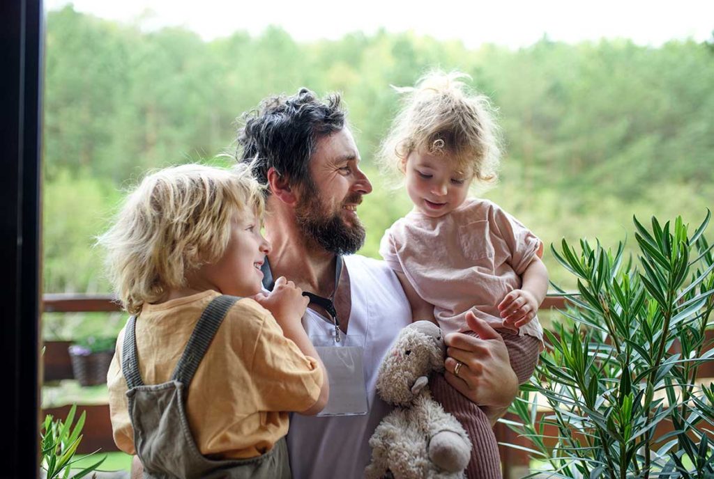 Maintaining Contact, dad with his two daughters in the countryside