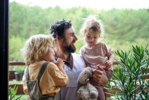 dad with his two daughters in the countryside