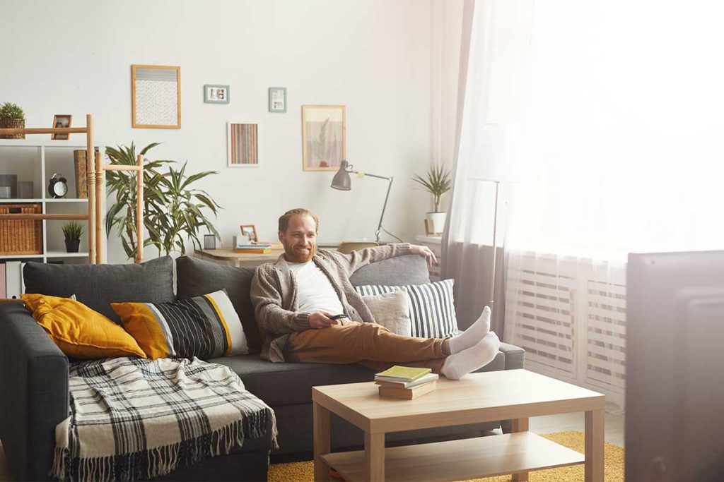 man sitting on sofa