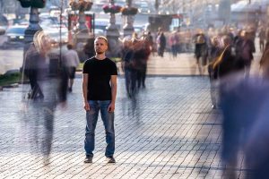 lonely man in crowded street